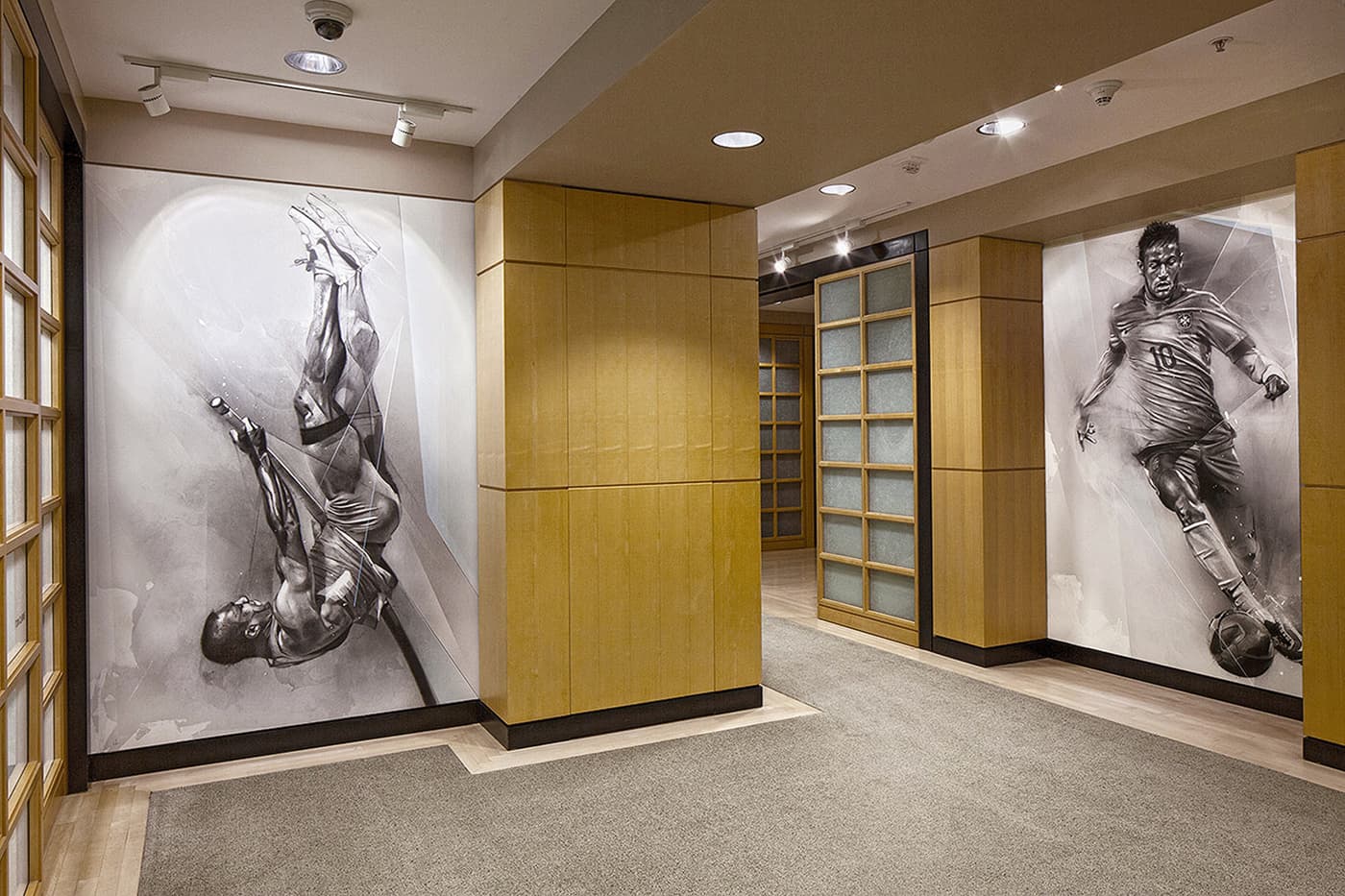 Nike hallway installation with pole vault and football murals