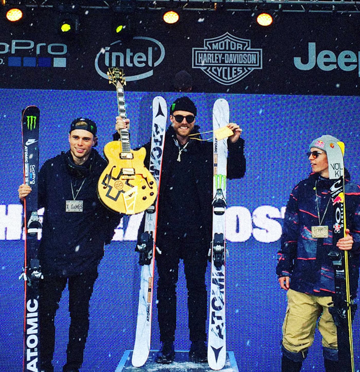 X Games podium scene showing the Atomic Infamous ski graphic with white marble-style artwork and black typography