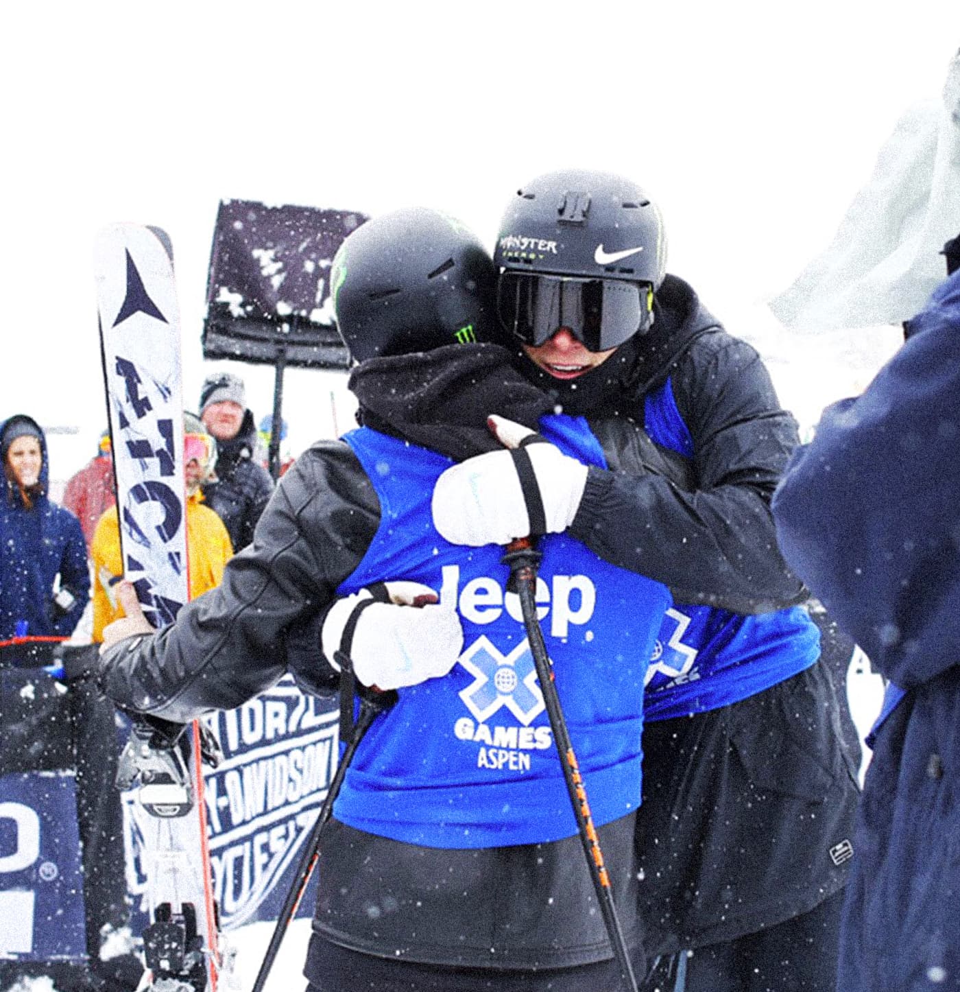 X Games scene showing an athlete holding Atomic Infamous skis with white marble-style graphics
