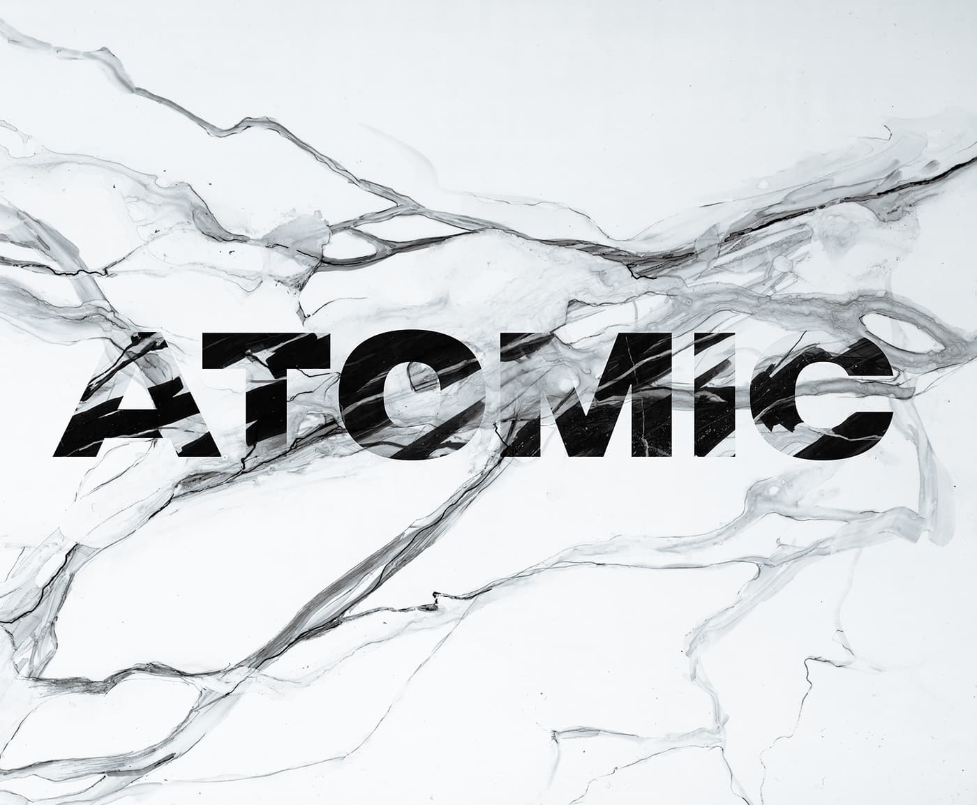 Close-up of the Atomic Infamous ski graphic with black vertical logo and white marble-style veining