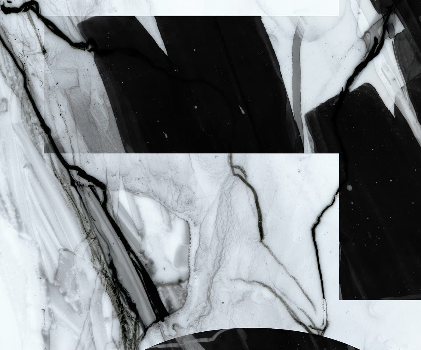Close-up of the Atomic Infamous ski graphic showing black logo shapes over white marble-style veining