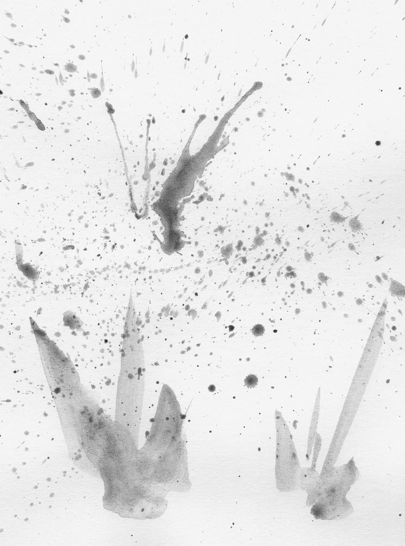 Abstract water-soluble graphite splatter tests with grey washes, droplets and expressive marks on white paper