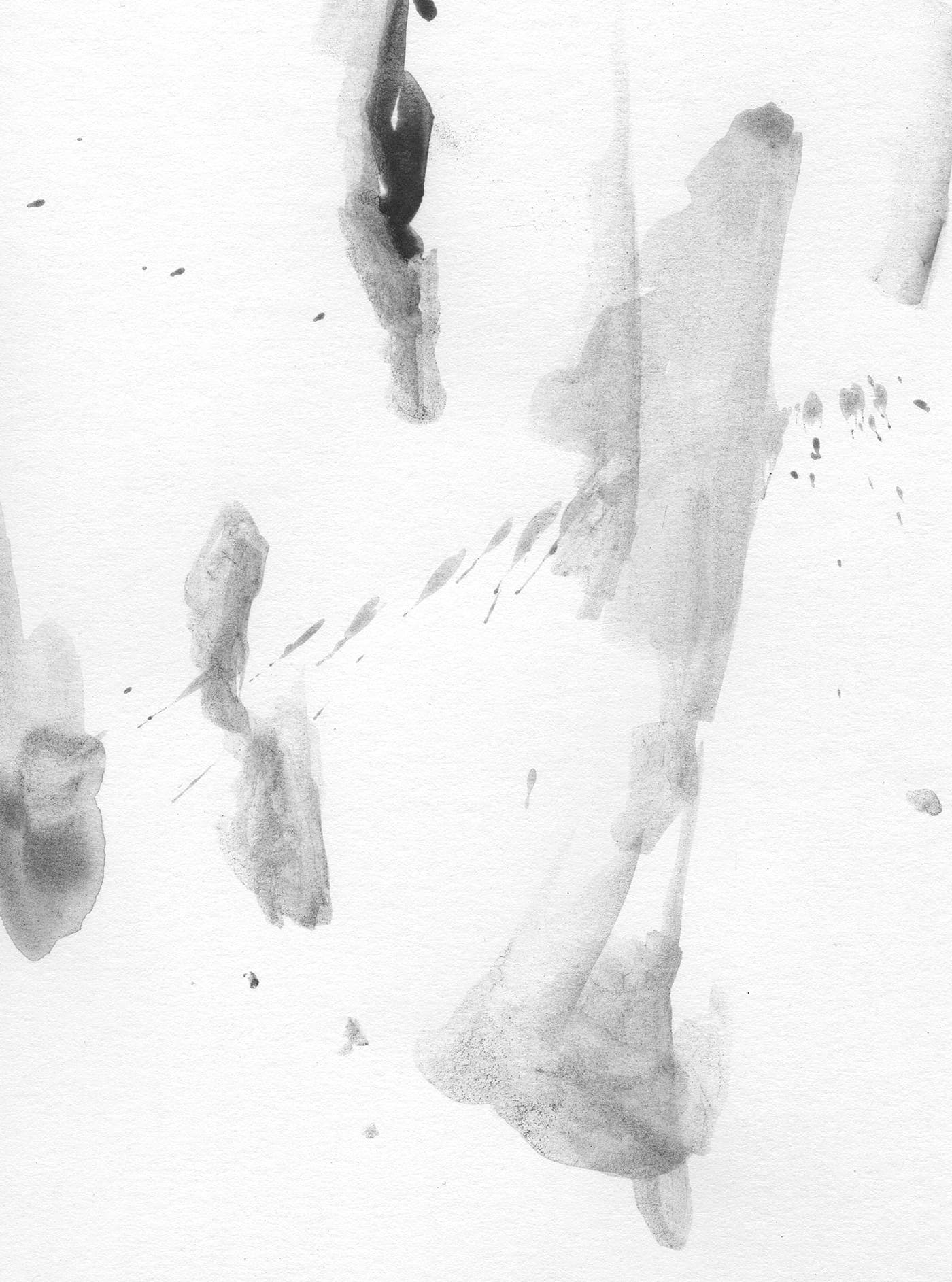 Abstract water-soluble graphite wash tests with pale grey marks and ink-like textures on white paper