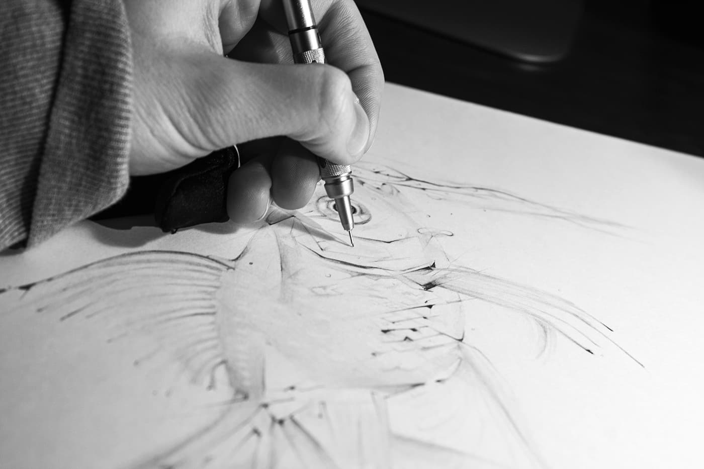 Hand drawing a fish illustration with a mechanical pencil