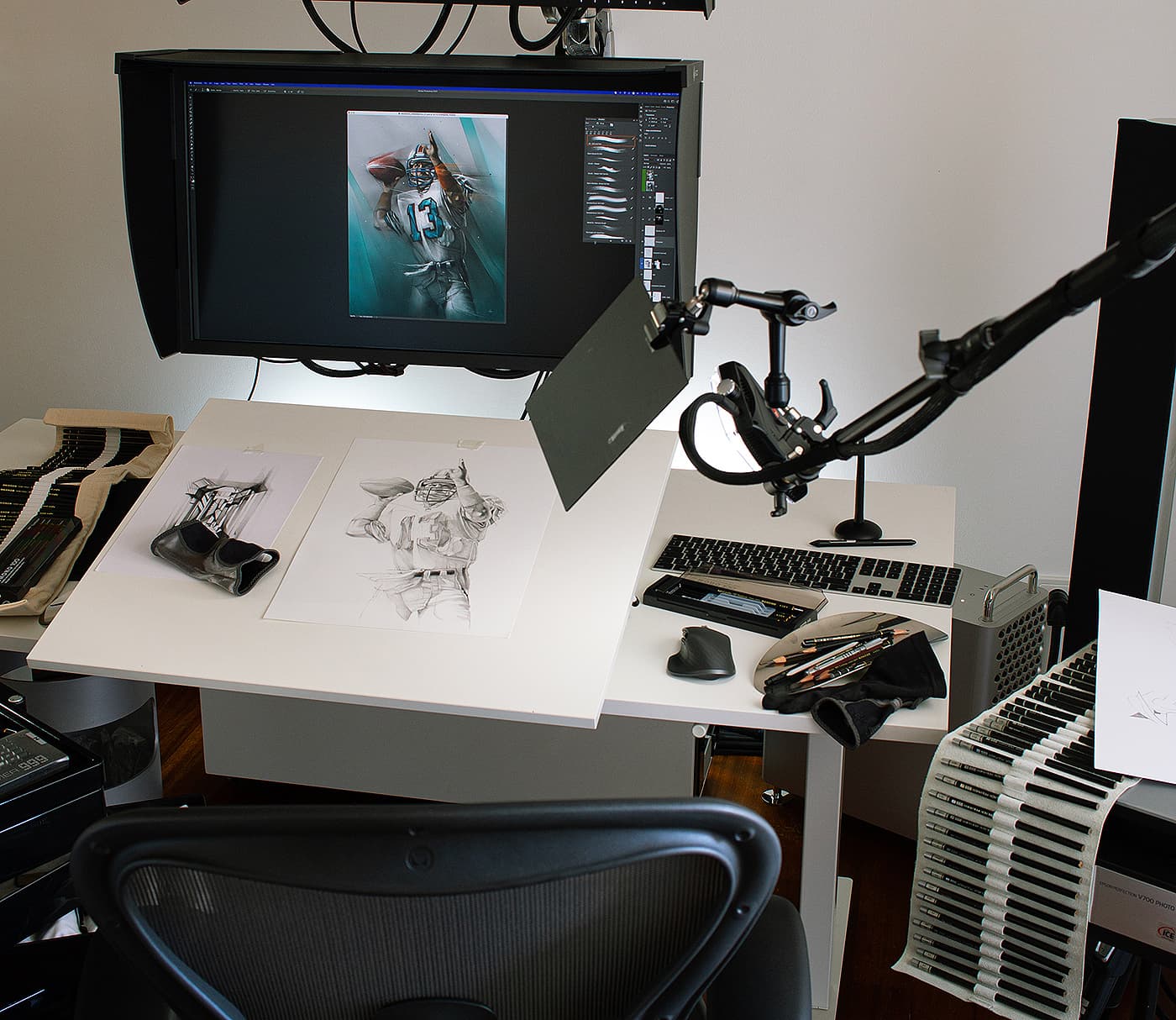 Studio workspace with football sketches and digital artwork