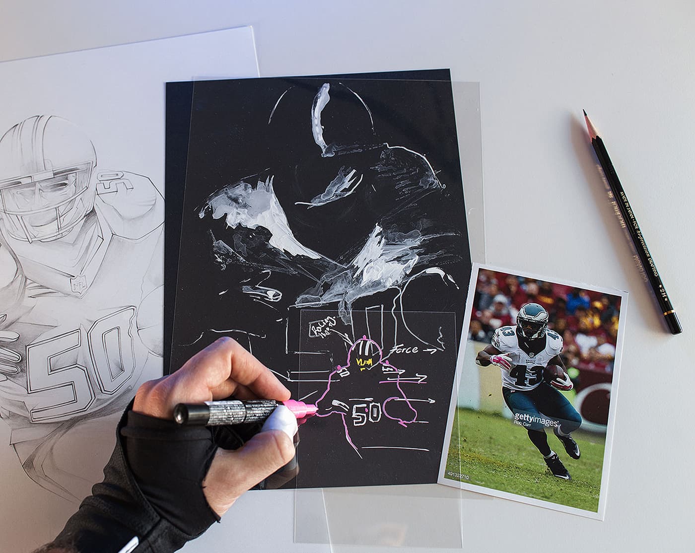 Hands marking football illustration studies with player reference photos
